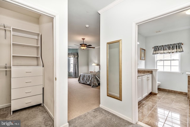 bathroom with toilet, a ceiling fan, visible vents, vanity, and baseboards