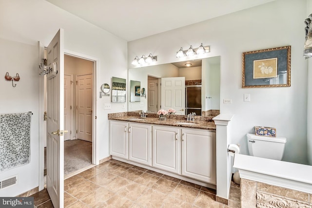 full bath with double vanity, visible vents, toilet, a sink, and a shower stall