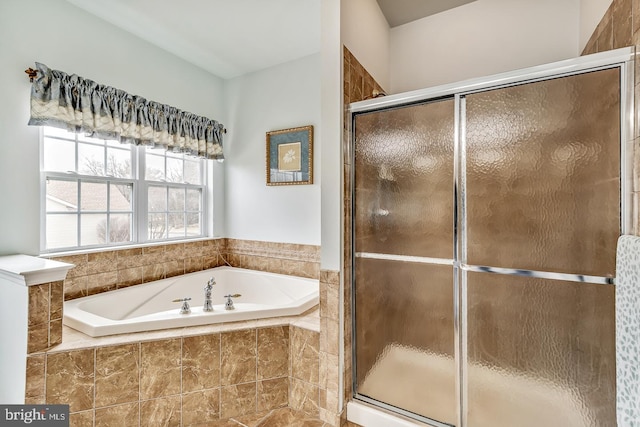 full bath featuring a garden tub and a shower stall