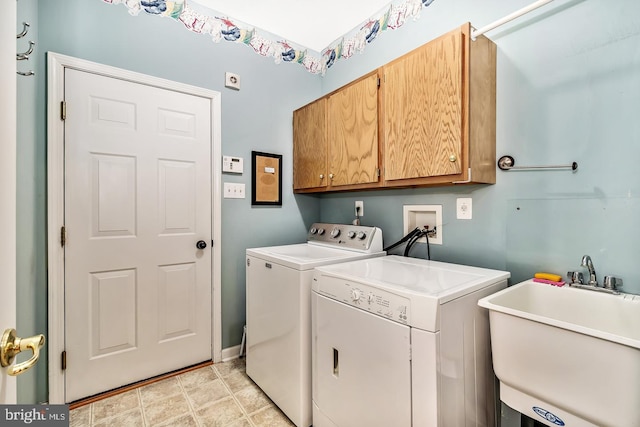 washroom with independent washer and dryer, cabinet space, and a sink