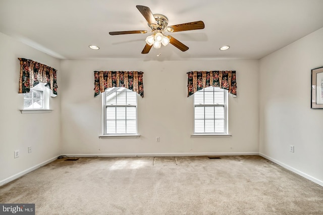 empty room featuring carpet floors, plenty of natural light, and baseboards