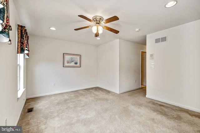 carpeted spare room featuring baseboards, ceiling fan, visible vents, and recessed lighting