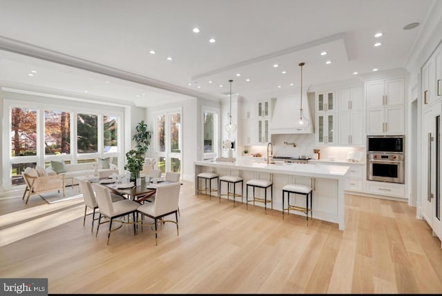 dining space with recessed lighting and light wood finished floors