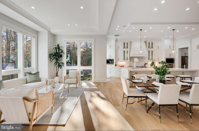 living area with light wood-type flooring and recessed lighting