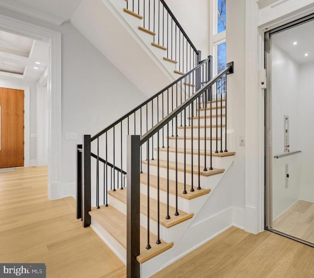 stairs with recessed lighting, baseboards, and wood finished floors