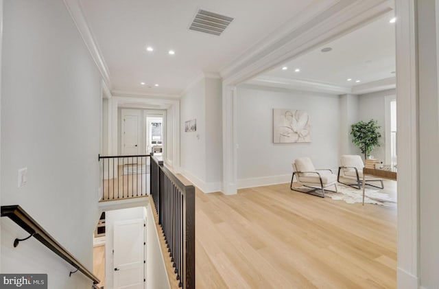 corridor with crown molding, recessed lighting, visible vents, an upstairs landing, and wood finished floors