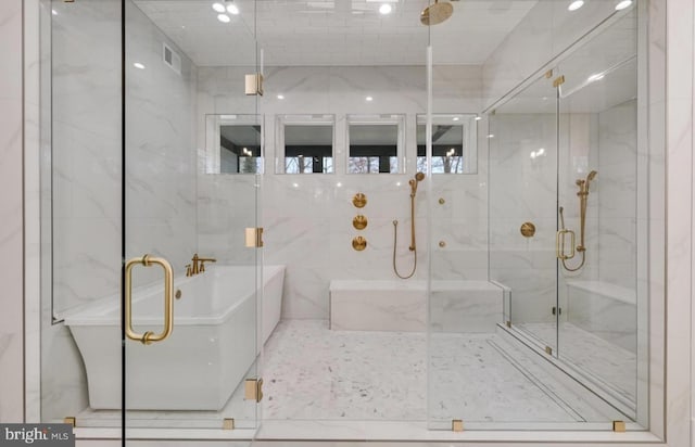 bathroom with a freestanding bath, a stall shower, and visible vents