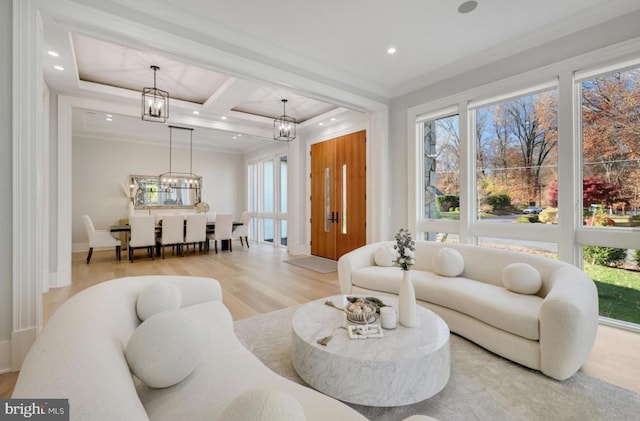 living area with a wealth of natural light, wood finished floors, crown molding, and recessed lighting