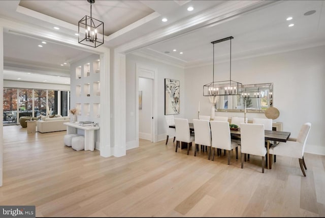 dining space featuring baseboards, a raised ceiling, wood finished floors, crown molding, and recessed lighting