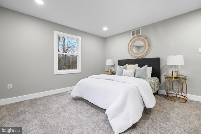 carpeted bedroom featuring recessed lighting, visible vents, and baseboards