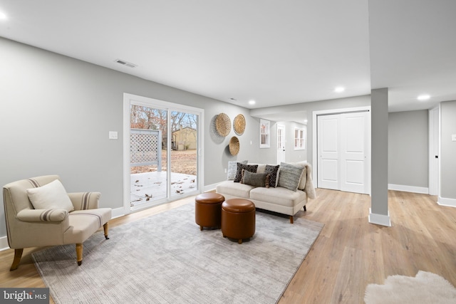 living area featuring light wood finished floors, recessed lighting, visible vents, and baseboards