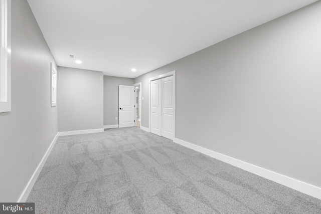 interior space with carpet, a closet, baseboards, and recessed lighting