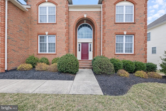 property entrance featuring brick siding