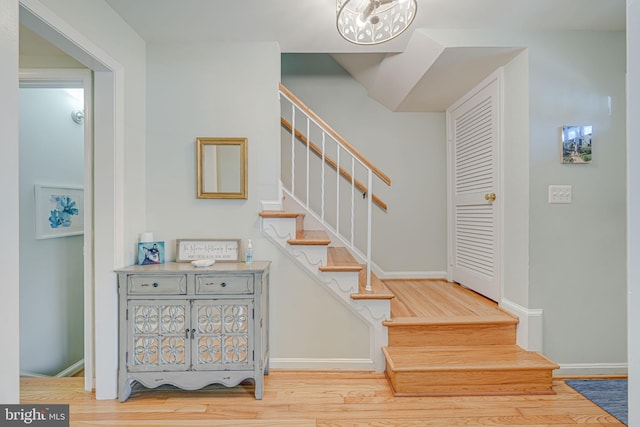 stairs with baseboards and wood finished floors