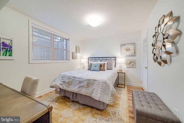 bedroom with light wood-style flooring and baseboards