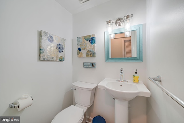 bathroom with visible vents and toilet