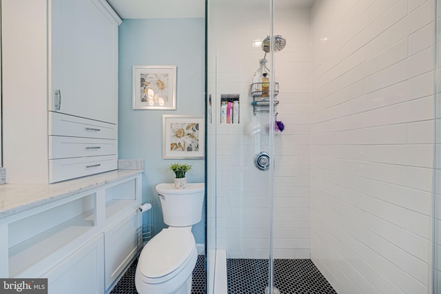 full bathroom featuring toilet and a stall shower