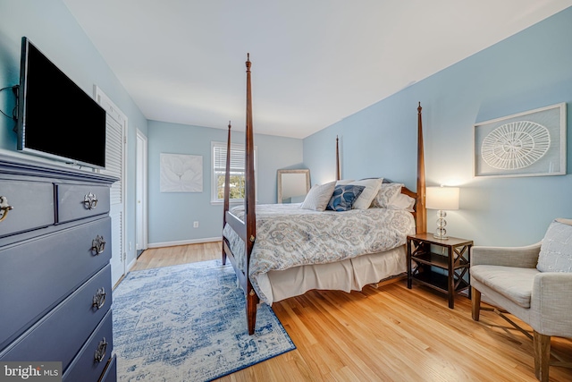 bedroom with baseboards and light wood-style flooring