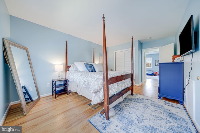 bedroom with baseboards and wood finished floors