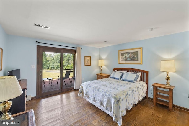 bedroom with access to outside, visible vents, and wood finished floors