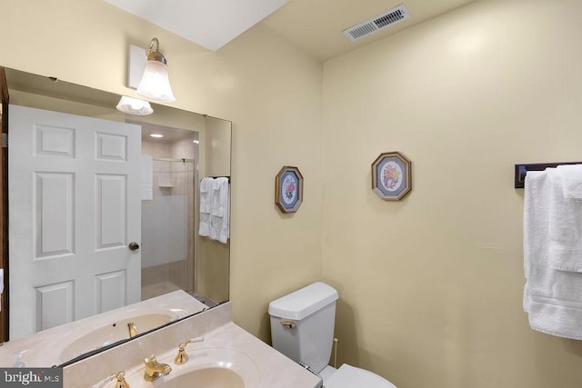 full bath with toilet, walk in shower, vanity, and visible vents