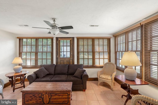 living room with visible vents, ceiling fan, a textured ceiling, and light tile patterned flooring