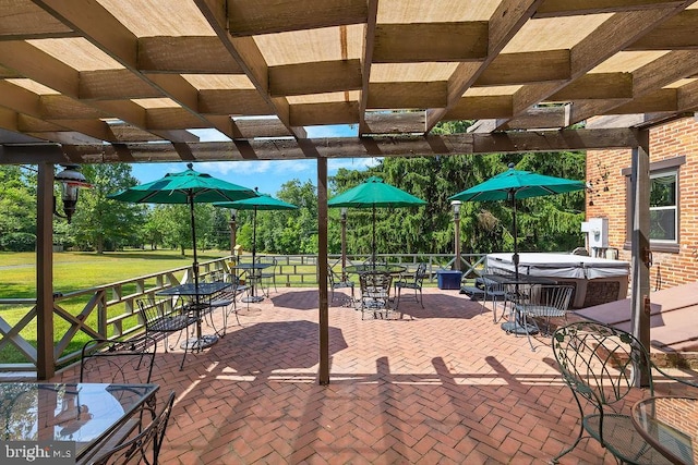 view of patio with outdoor dining area, a hot tub, and a pergola