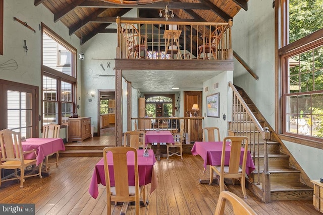 interior space with wood ceiling, wood-type flooring, beam ceiling, and stairs