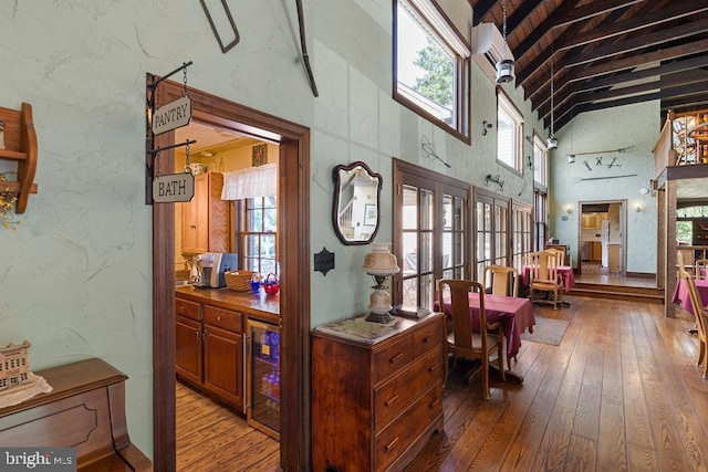 interior space with a towering ceiling and wood-type flooring