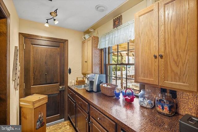 kitchen featuring dark countertops and a sink