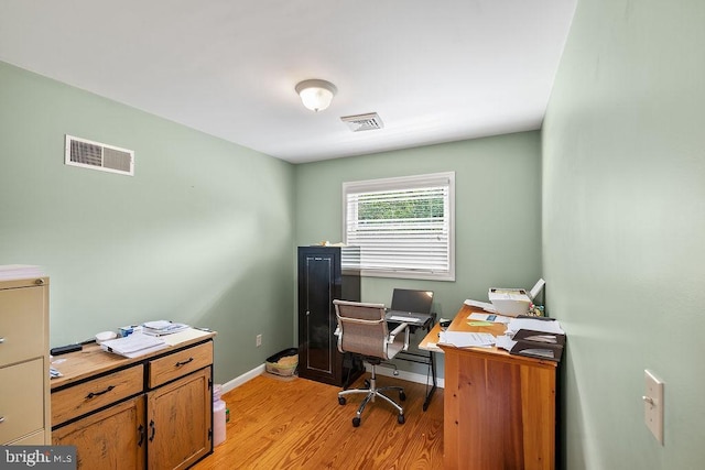 office featuring light wood-style floors, visible vents, and baseboards