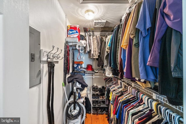 spacious closet featuring wood finished floors and electric panel