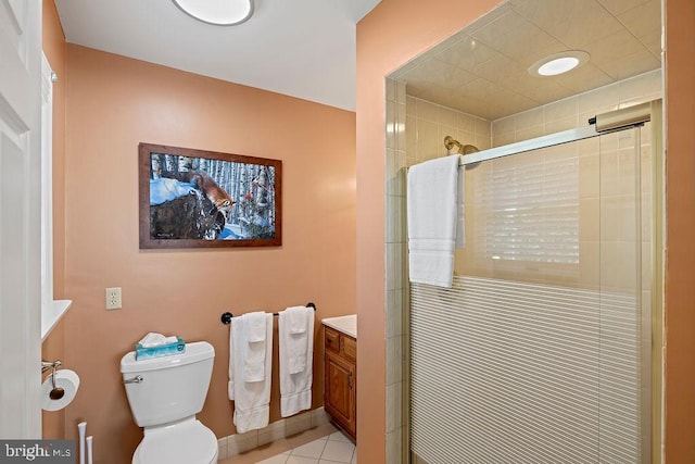 bathroom featuring toilet, a shower stall, tile patterned flooring, and vanity