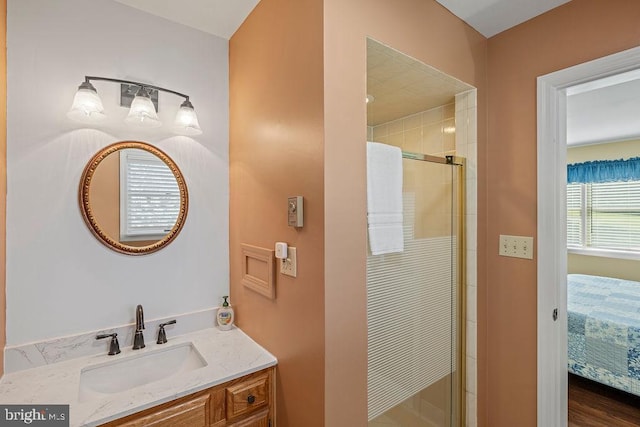 ensuite bathroom with a shower stall, connected bathroom, and vanity