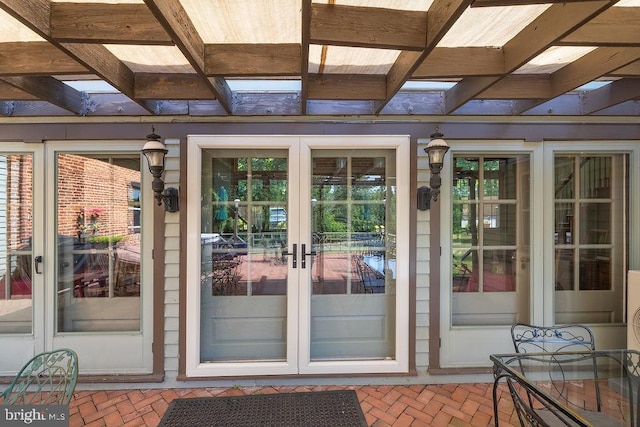 entrance to property featuring a pergola and french doors