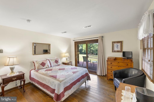 bedroom featuring baseboards, access to outside, visible vents, and wood finished floors