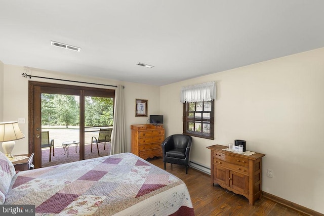 bedroom featuring dark wood-style flooring, access to outside, baseboard heating, and visible vents