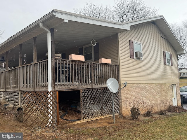 view of side of home with cooling unit and a wooden deck