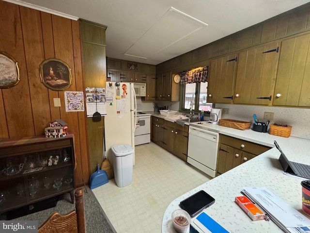 kitchen featuring a sink, light floors, white appliances, and light countertops