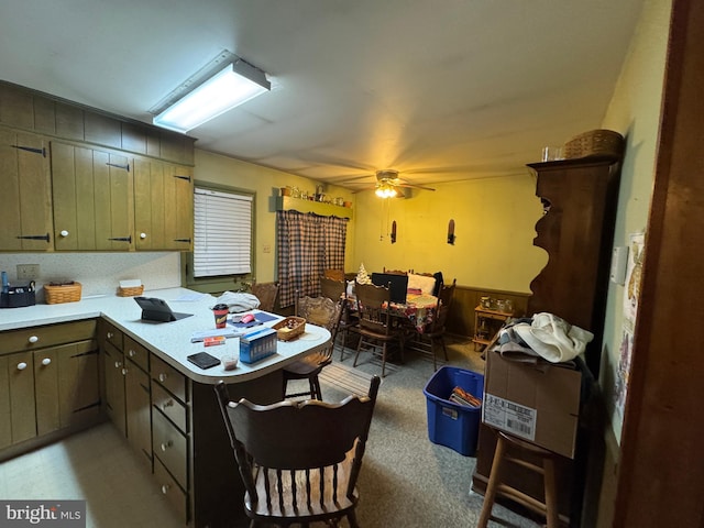 kitchen with a peninsula, light countertops, and a ceiling fan