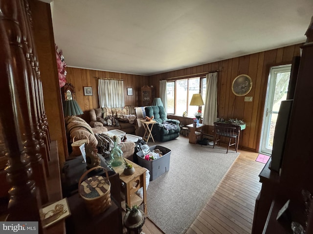 living area featuring hardwood / wood-style floors and wooden walls