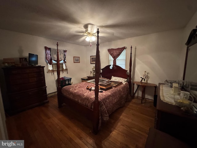 bedroom featuring a baseboard radiator, wood finished floors, and a ceiling fan