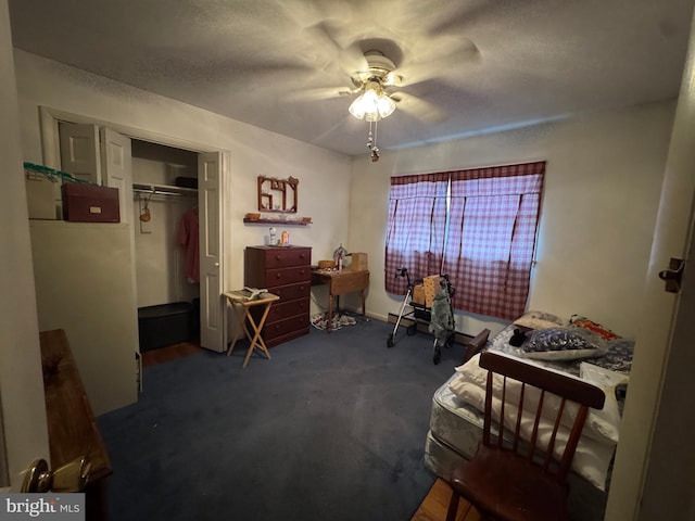 bedroom with a closet, dark carpet, and a ceiling fan