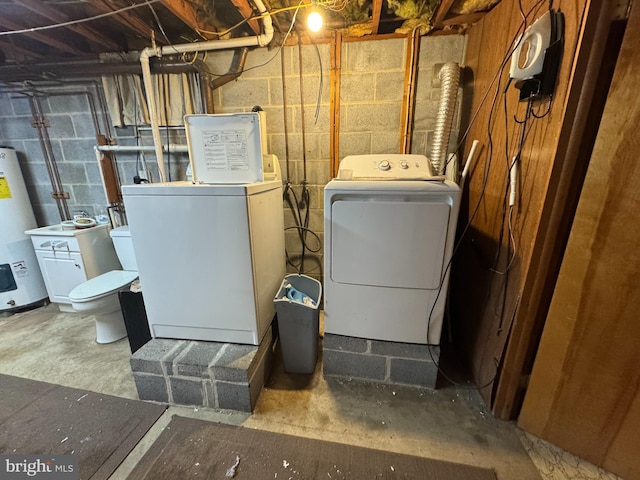 clothes washing area with washer and dryer, laundry area, and water heater