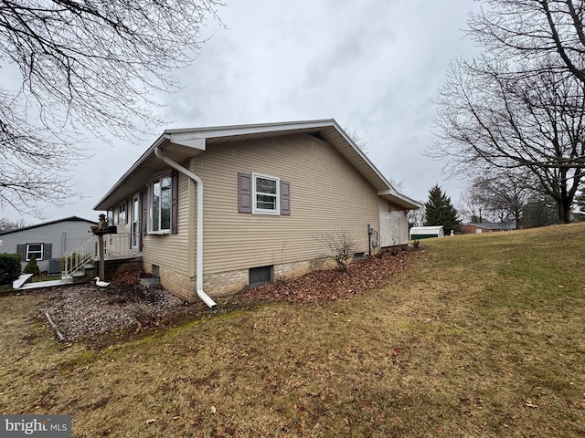 view of home's exterior with a lawn