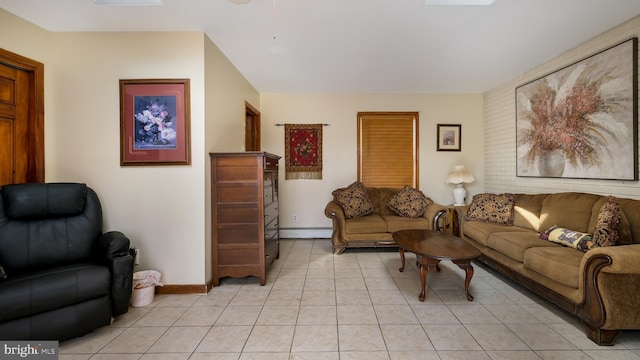 living area featuring light tile patterned floors, baseboards, and a baseboard heating unit