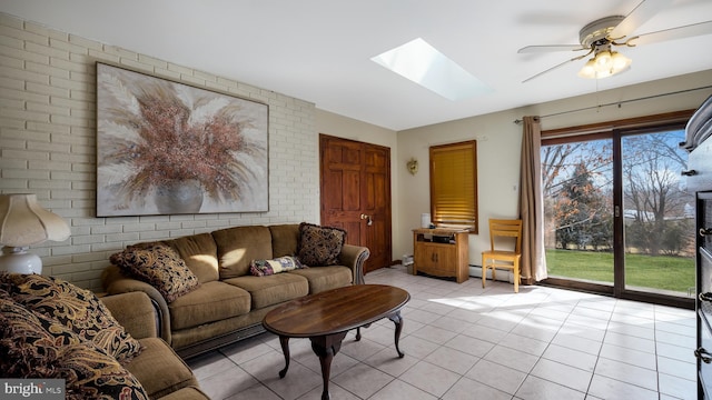 living room featuring a skylight, a baseboard radiator, ceiling fan, and light tile patterned flooring