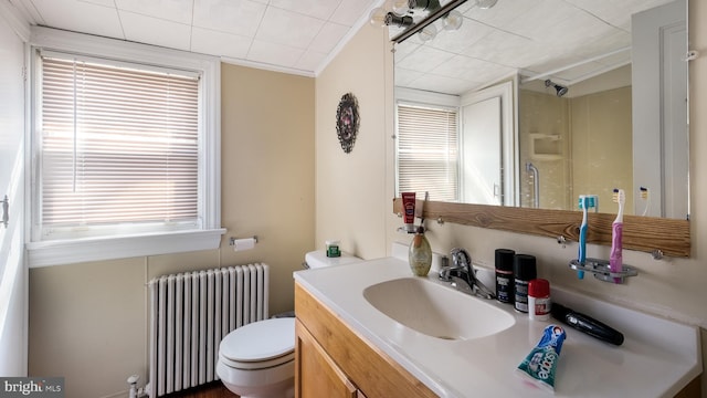 full bath featuring a healthy amount of sunlight, radiator heating unit, toilet, and a shower