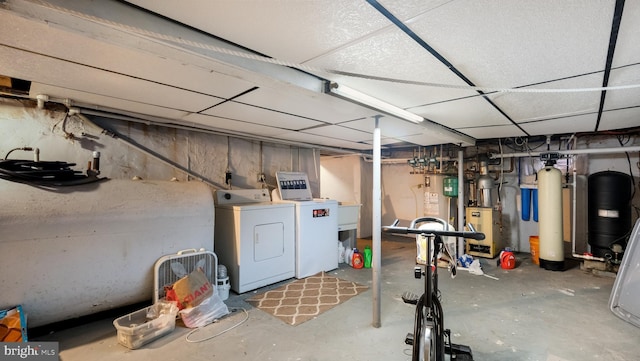 unfinished below grade area featuring independent washer and dryer and heating fuel