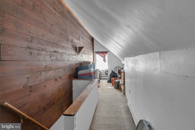 additional living space featuring vaulted ceiling and carpet floors